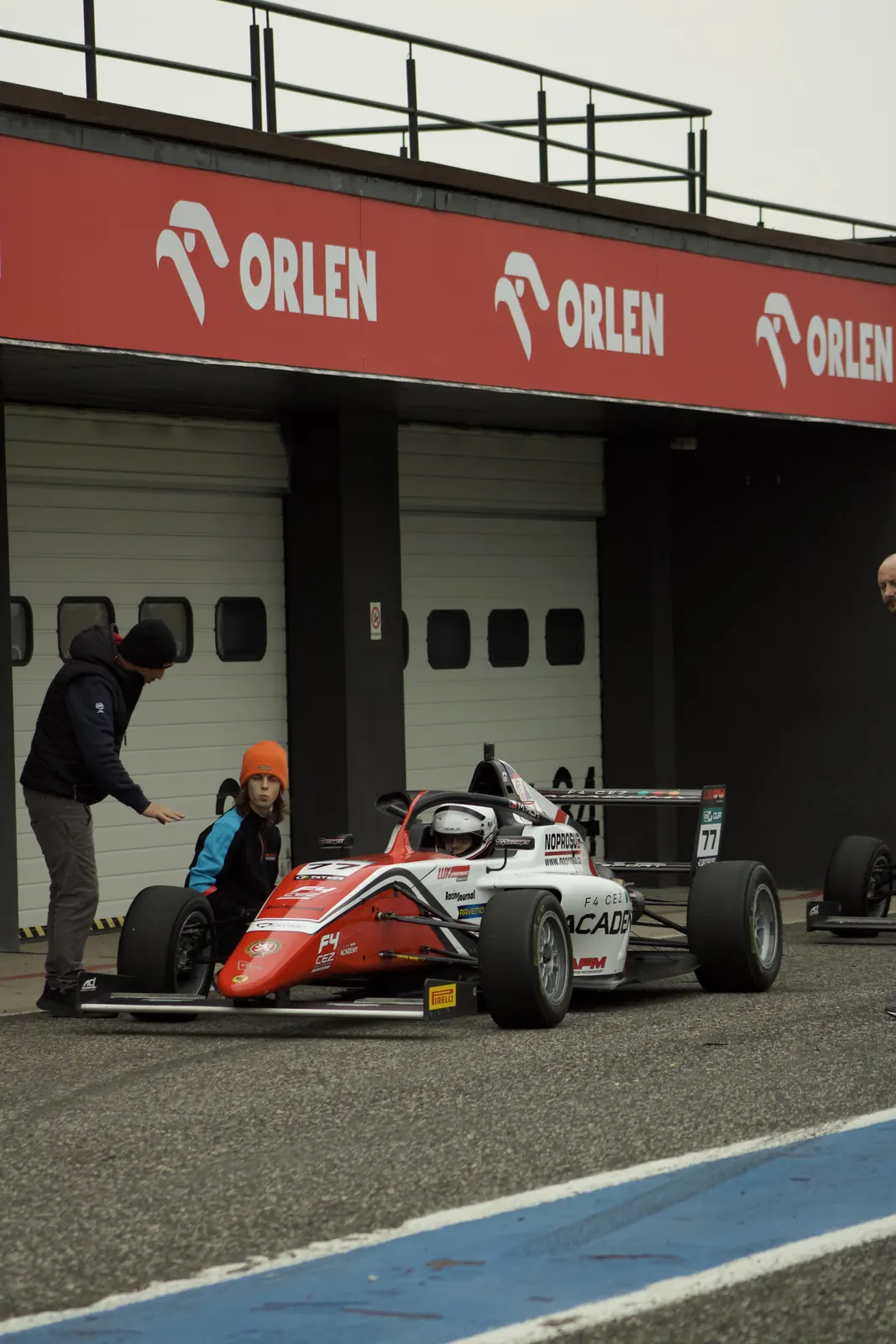 The Tatuus Formula 4 car outside the garages