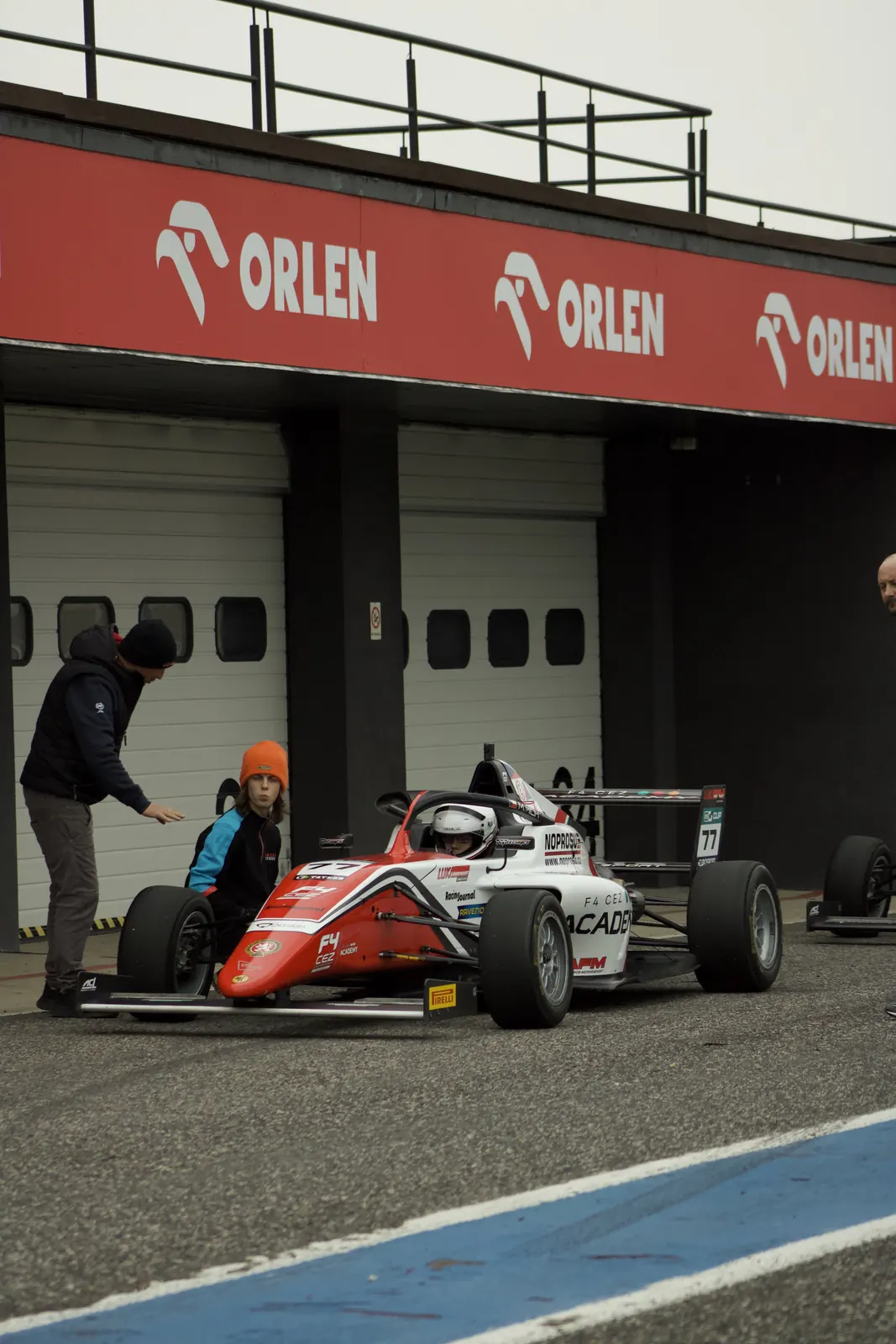 Oliver in the Formula 4 car outside the garages