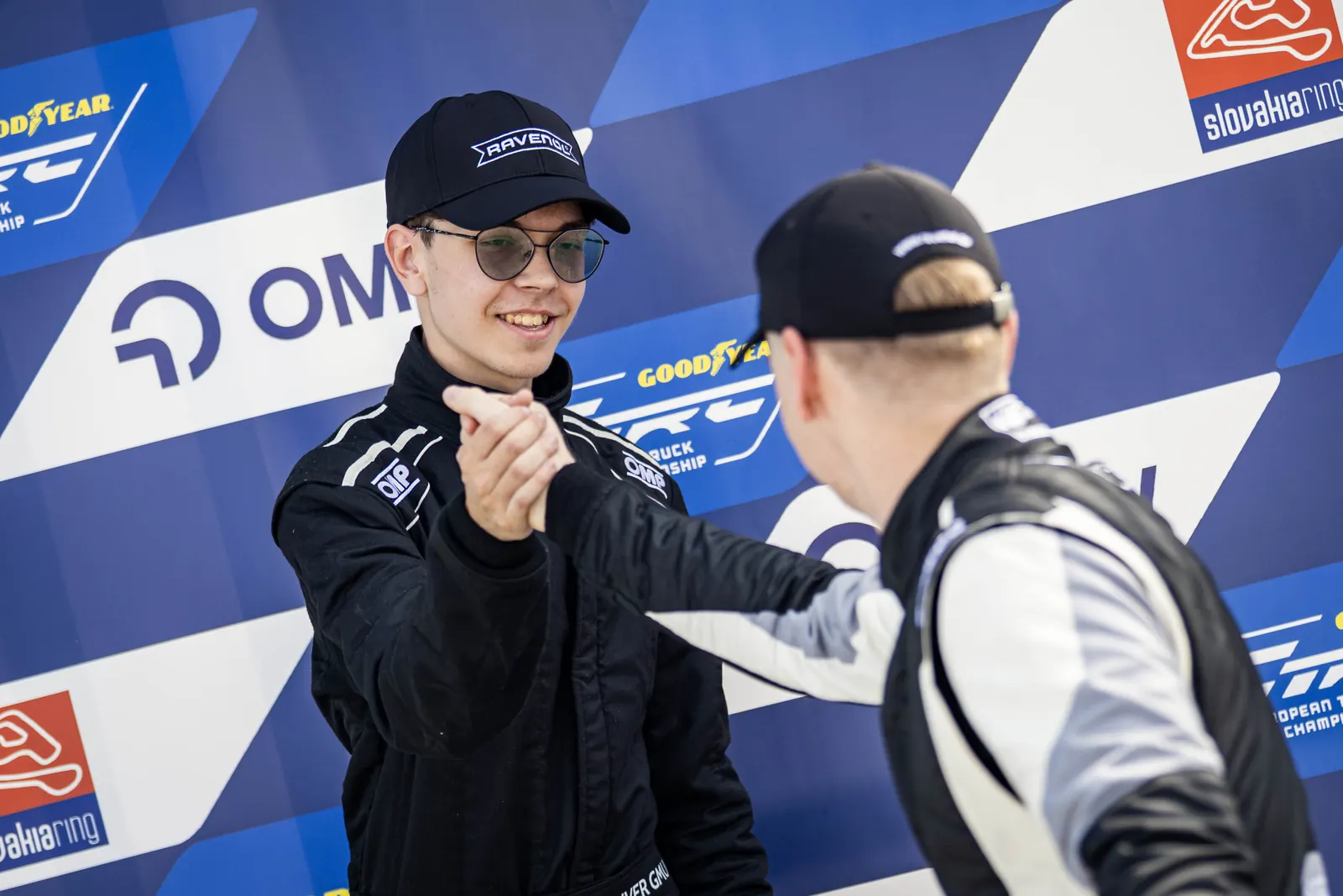 Oliver shaking hands with a partner in the paddock