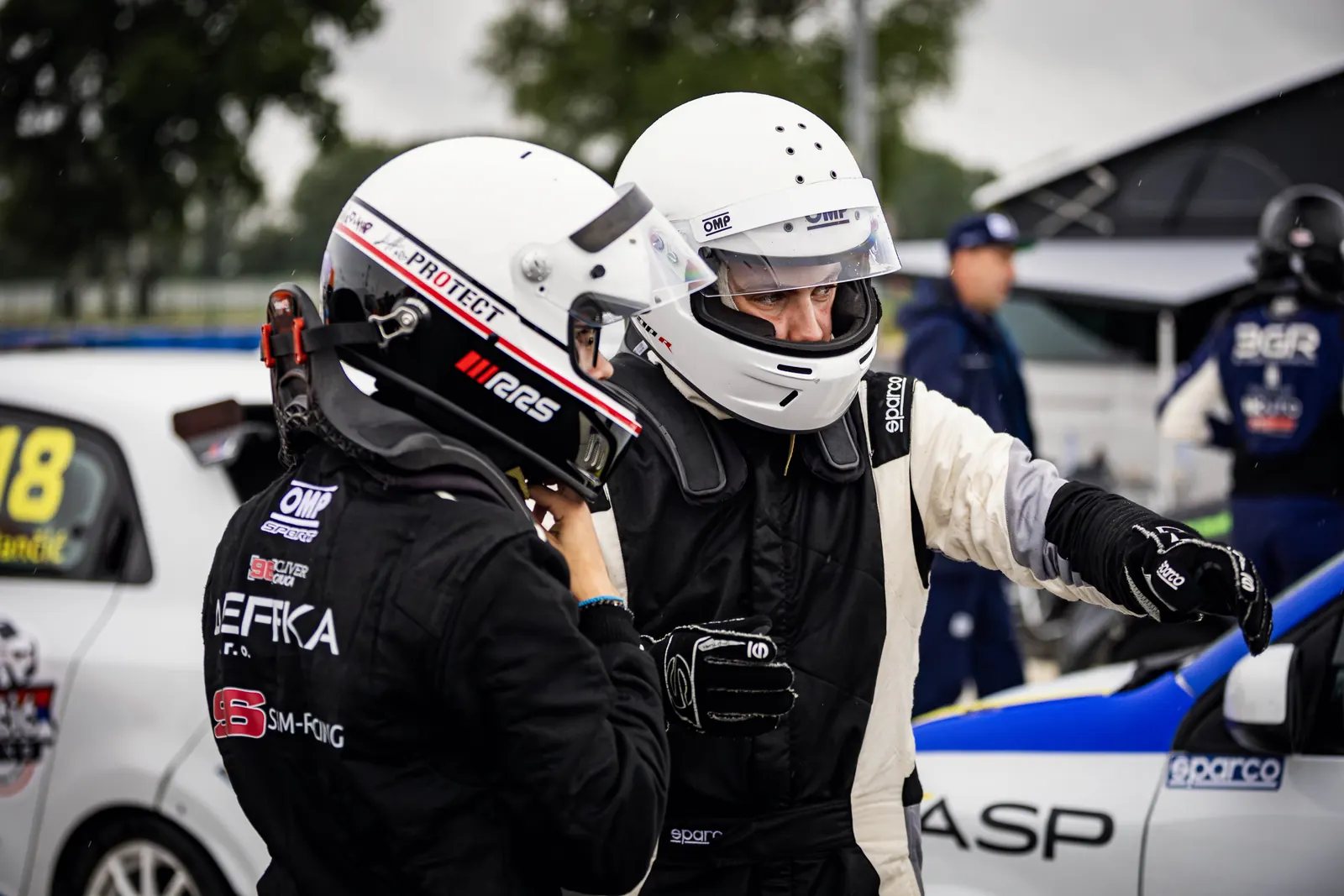 Oliver getting ready with a teammate in the paddock