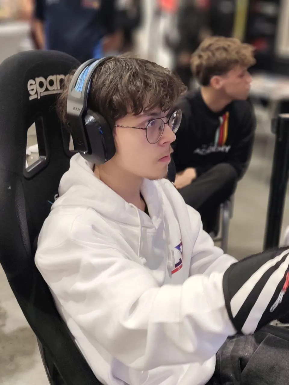 Oliver racing on a simulator at an event